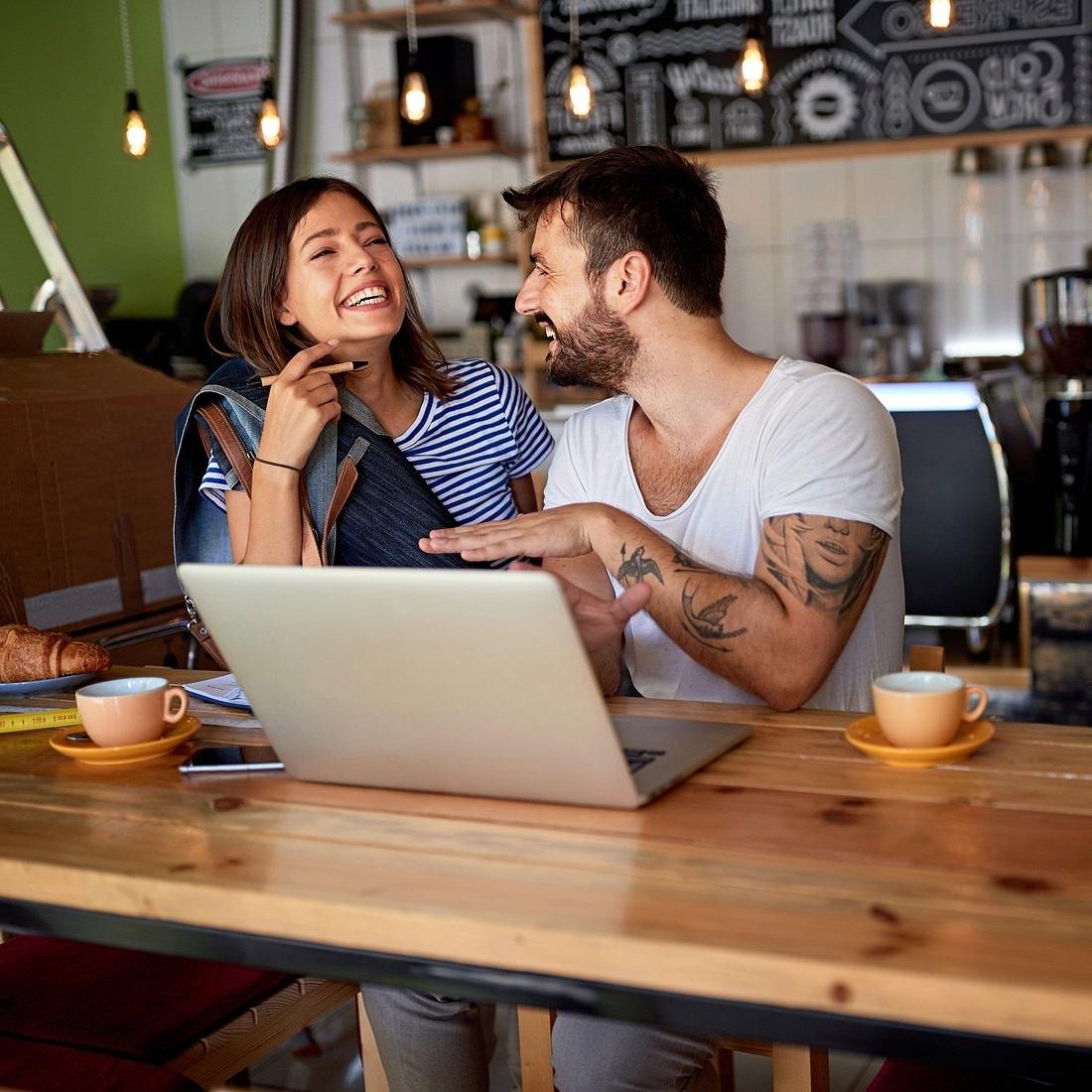 Coffee shop owners using a computer.